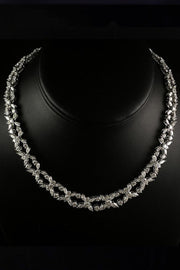 Platinum necklace with marquise and brilliant diamonds on a black necklace display.