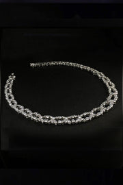 Platinum necklace with marquise and brilliant diamonds laying down on a black background