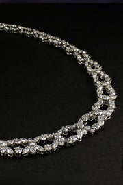 Closeup of platinum necklace with marquise and brilliant diamonds on a black background