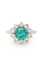 Platinum ring with paraiba surrounded by diamonds on white background