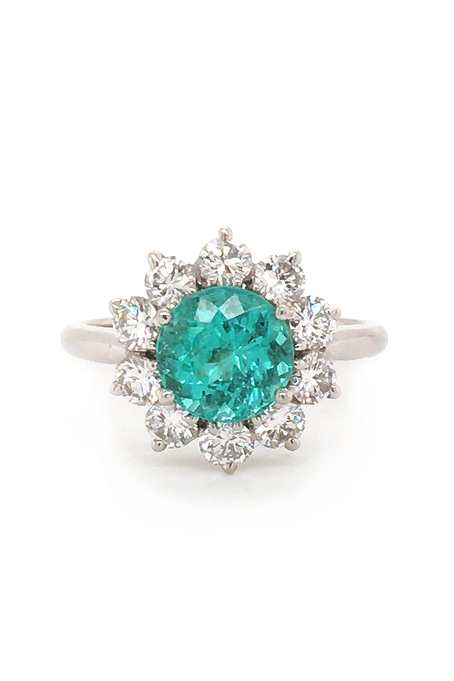 Platinum ring with paraiba surrounded by diamonds on white background