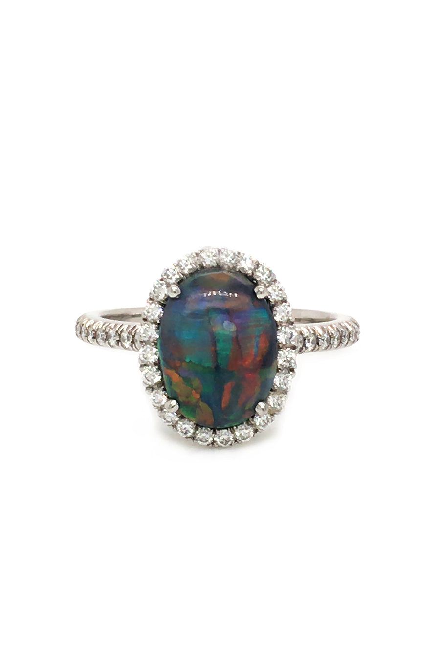 Platinum ring with a black opal and diamonds on a white background