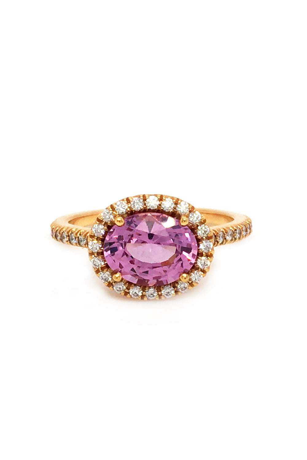 20K pink gold ring with pink sapphire and diamond halo on white background