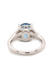 Back view of 18K white gold ring featuring an oval aquamarine and diamonds on white background