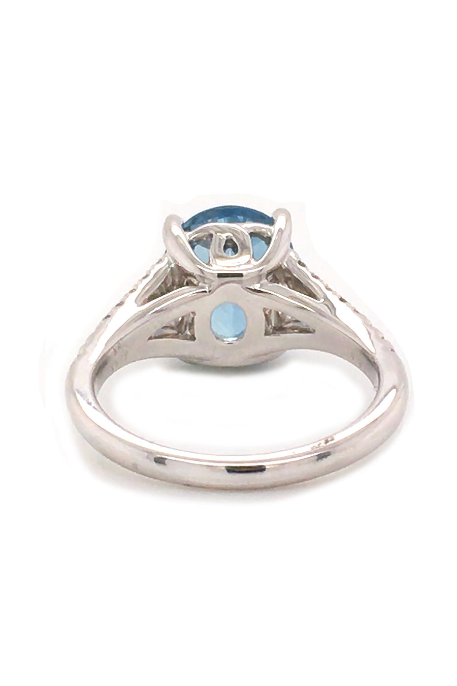 Back view of 18K white gold ring featuring an oval aquamarine and diamonds on white background