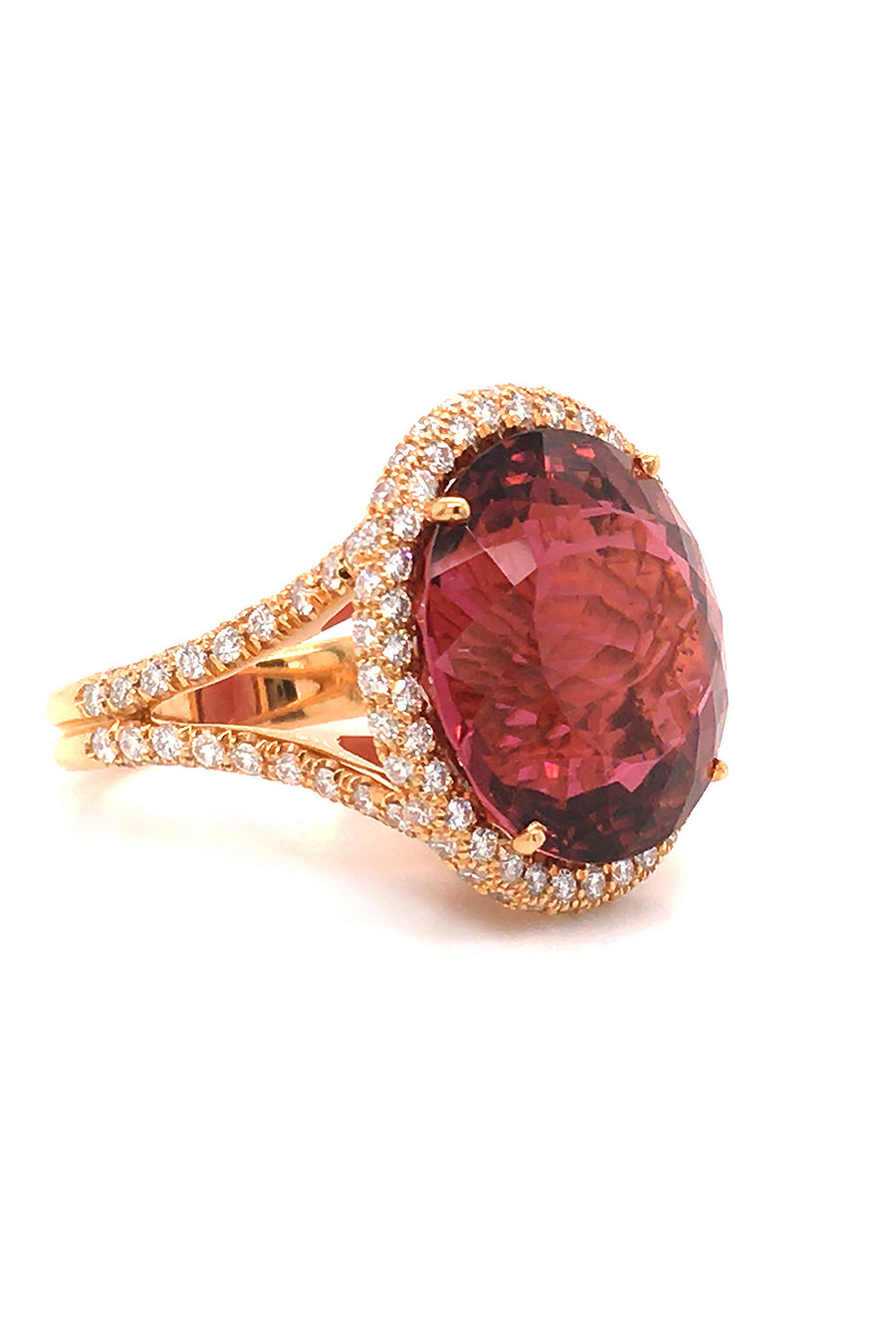Side view of 20K pink gold ring with large cinnamon tourmaline with diamond halo on a white back background