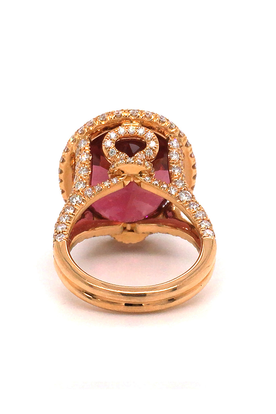 Back view of 20K pink gold ring with large cinnamon tourmaline with diamond halo on a white back background