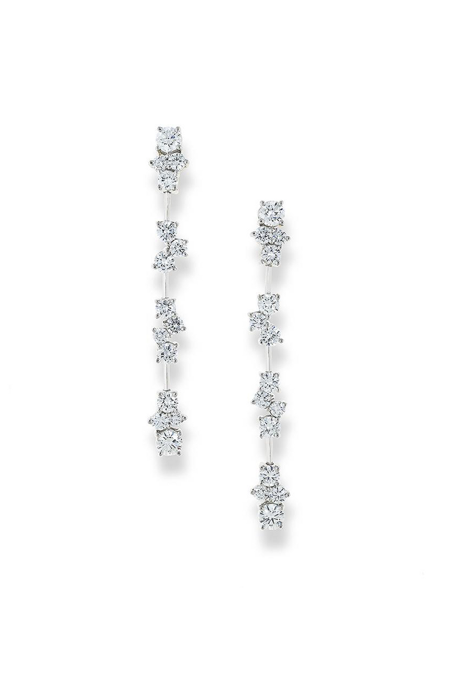 Platinum drop earrings featuring multiple segments with diamond clusters on a white background,.