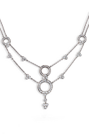 Platinum necklace with lace-inspired motif with diamonds on a white background.