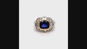 Video of rotating ring with blue gemstone and diamonds on white background