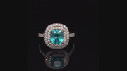 Video of rotating ring with blue  green gemstone and diamonds on black background
