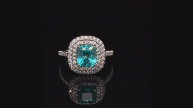 Video of rotating ring with blue  green gemstone and diamonds on black background